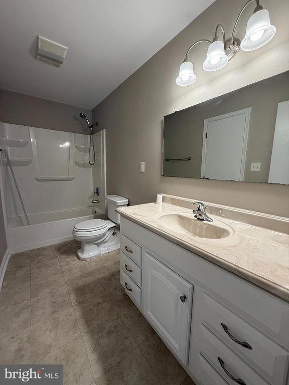 11503 Wilderness Park Dr, Spotsylvania, VA 22551 - bathroom with vanity, bathtub / shower combination, toilet, and tile patterned floors