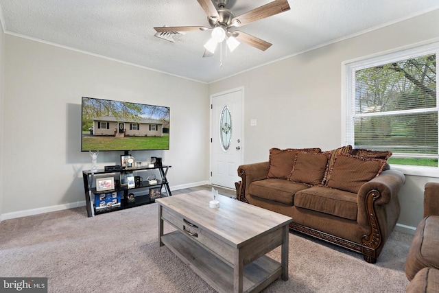living room featuring crown molding, carpet, a ceiling fan, and baseboards