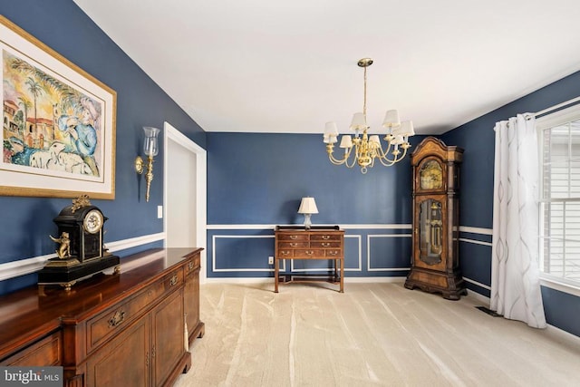 604 Mt Pleasant Dr, Locust Grove, VA 22508 - dining space featuring light colored carpet, wainscoting, a healthy amount of sunlight, and a notable chandelier