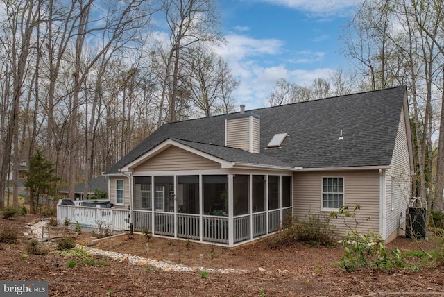 604 Mt Pleasant Dr, Locust Grove, VA 22508 - back of property with a sunroom, a shingled roof, and a chimney
