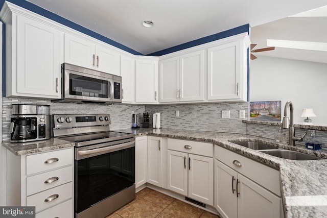 604 Mt Pleasant Dr, Locust Grove, VA 22508 - kitchen with white cabinetry, appliances with stainless steel finishes, decorative backsplash, and a sink
