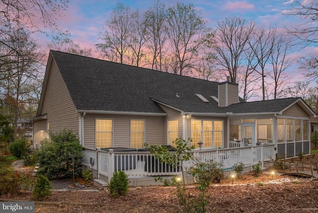 604 Mt Pleasant Dr, Locust Grove, VA 22508 - back of property with a chimney, a sunroom, and a shingled roof