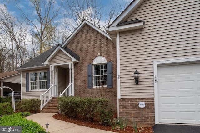 604 Mt Pleasant Dr, Locust Grove, VA 22508 - view of front facade with brick siding and a garage