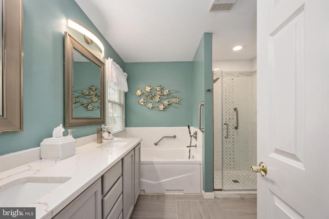 604 Mt Pleasant Dr, Locust Grove, VA 22508 - bathroom with a stall shower, visible vents, a sink, a garden tub, and double vanity
