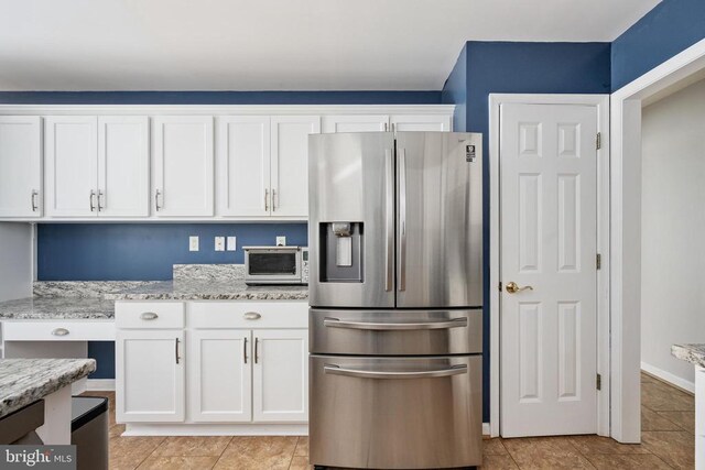 604 Mt Pleasant Dr, Locust Grove, VA 22508 - kitchen featuring white cabinetry, light stone counters, light tile patterned flooring, and stainless steel refrigerator with ice dispenser