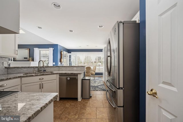 604 Mt Pleasant Dr, Locust Grove, VA 22508 - kitchen with a sink, a peninsula, white cabinetry, light stone countertops, and appliances with stainless steel finishes