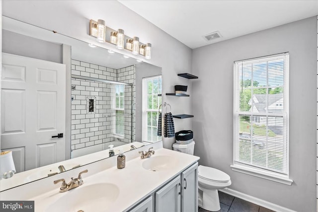6915 Yeoman Ct, Fredericksburg, VA 22407 - bathroom with tile patterned flooring, a tile shower, double vanity, toilet, and baseboards