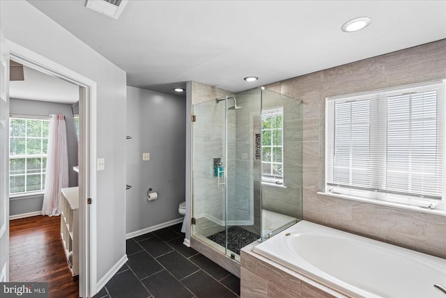 6915 Yeoman Ct, Fredericksburg, VA 22407 - bathroom featuring a bath, a stall shower, toilet, tile patterned floors, and baseboards