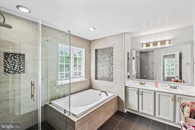 6915 Yeoman Ct, Fredericksburg, VA 22407 - bathroom featuring healthy amount of natural light, a bath, a shower stall, double vanity, and recessed lighting