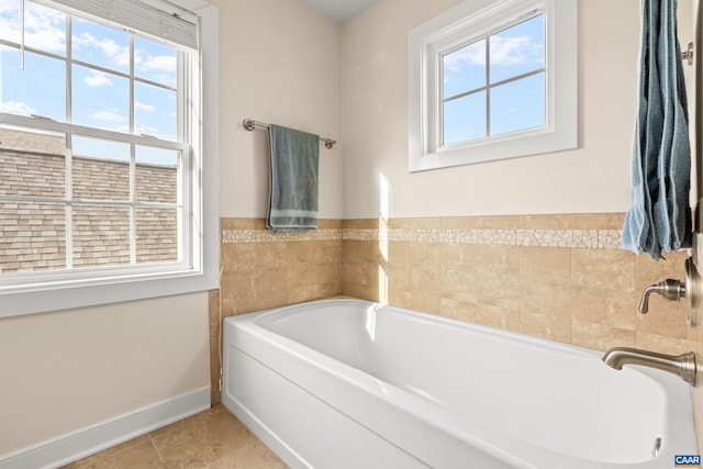 bathroom featuring tile patterned floors and a garden tub