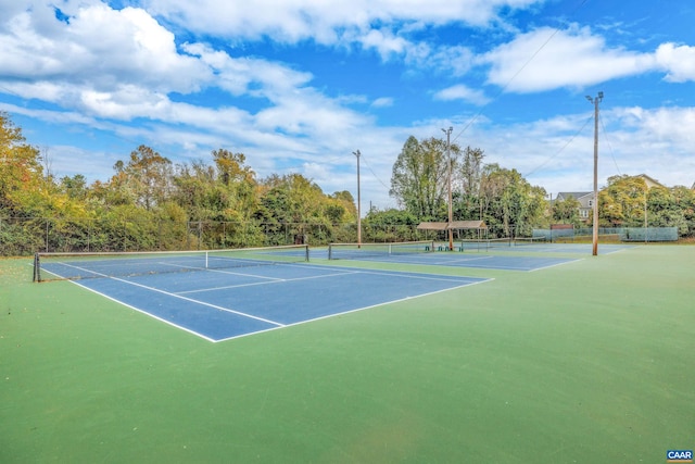 view of tennis court featuring fence