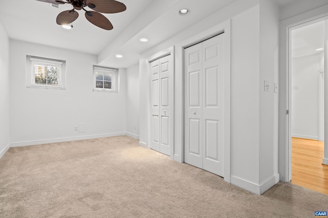 unfurnished bedroom with a ceiling fan, recessed lighting, carpet, baseboards, and two closets