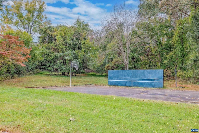 view of home's community with a yard and a view of trees