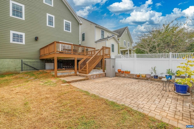 back of house featuring a yard, a patio area, a deck, and fence
