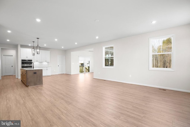 1 Blakely St, Fredericksburg, VA 22408 - unfurnished living room featuring light wood finished floors, recessed lighting, baseboards, and a sink