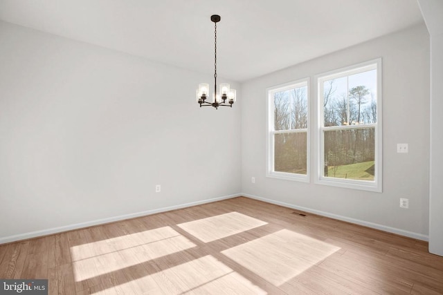 1 Blakely St, Fredericksburg, VA 22408 - empty room featuring a chandelier, wood finished floors, and baseboards