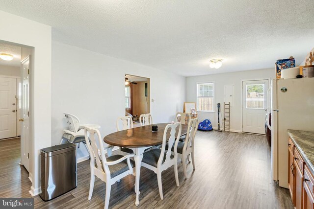 301 Charles St, Gordonsville, VA 22942 - dining area featuring a textured ceiling, wood finished floors, and baseboards