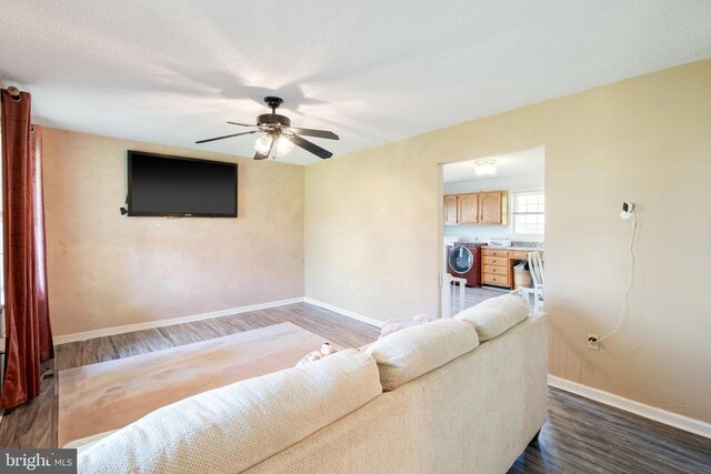 301 Charles St, Gordonsville, VA 22942 - living area featuring wood finished floors, ceiling fan, washer / dryer, and baseboards