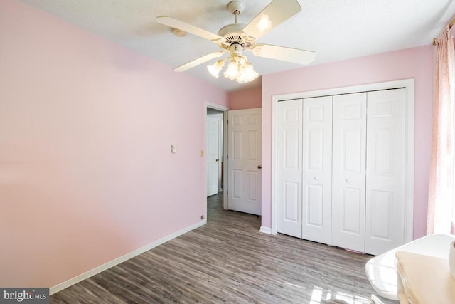 301 Charles St, Gordonsville, VA 22942 - unfurnished bedroom featuring baseboards, wood finished floors, a closet, and a ceiling fan