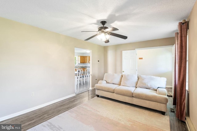 301 Charles St, Gordonsville, VA 22942 - living room featuring wood finished floors, ceiling fan, baseboards, and a textured ceiling