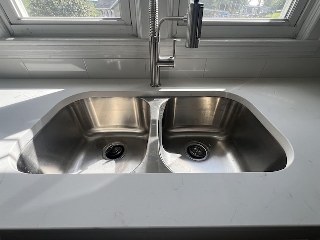kitchen view of a sink and light countertops