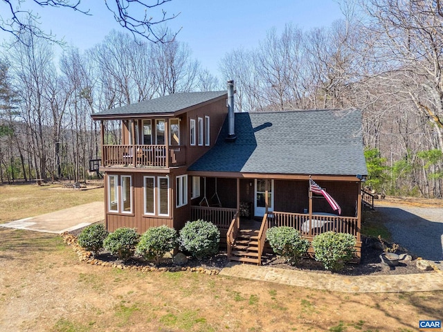 1481 Red Bird Dr, Stanardsville, VA 22973 - back of property featuring a shingled roof, covered porch, a yard, and a balcony