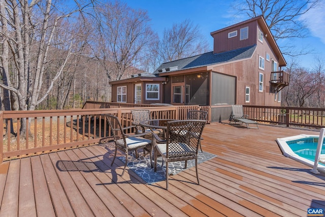 1481 Red Bird Dr, Stanardsville, VA 22973 - wooden deck featuring outdoor dining space, a sunroom, and a fenced in pool