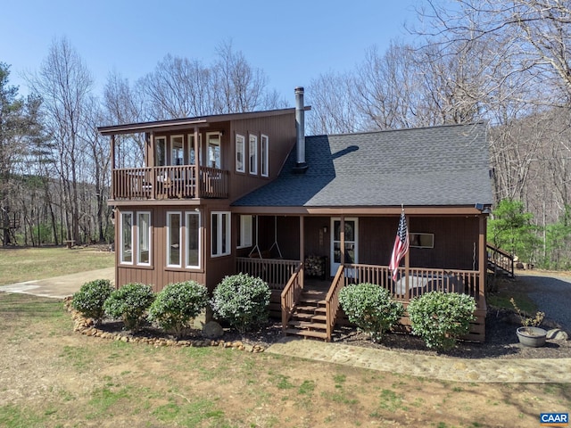 1481 Red Bird Dr, Stanardsville, VA 22973 - view of front of house with a shingled roof, a front lawn, and a balcony