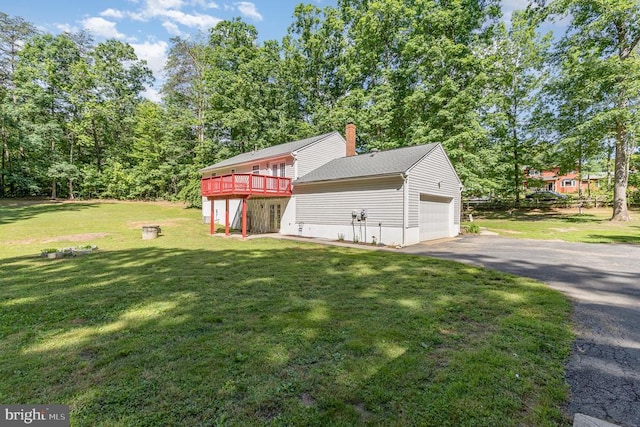 7001 Aspen Ln, Spotsylvania, VA 22551 - view of property exterior featuring a deck, asphalt driveway, a yard, a chimney, and a garage