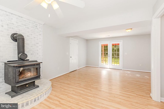 7001 Aspen Ln, Spotsylvania, VA 22551 - unfurnished living room featuring wood finished floors, a wood stove, baseboards, and a ceiling fan
