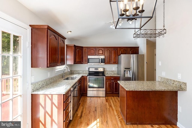 7001 Aspen Ln, Spotsylvania, VA 22551 - kitchen with stainless steel appliances, a sink, a chandelier, light wood-style floors, and vaulted ceiling