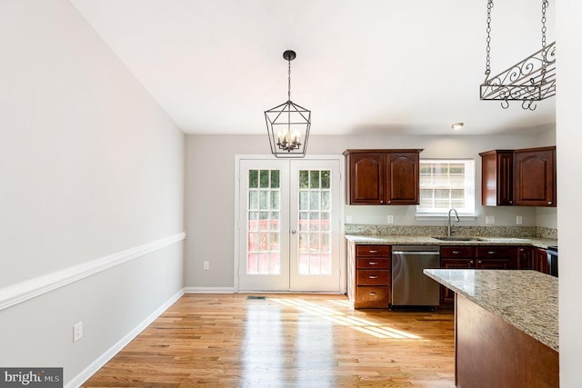 7001 Aspen Ln, Spotsylvania, VA 22551 - kitchen featuring dishwasher, a chandelier, light wood-style flooring, pendant lighting, and a sink