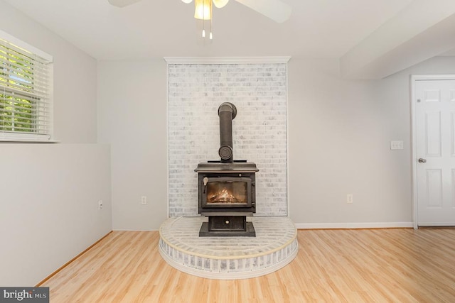 7001 Aspen Ln, Spotsylvania, VA 22551 - detailed view of wood finished floors, ceiling fan, and a wood stove