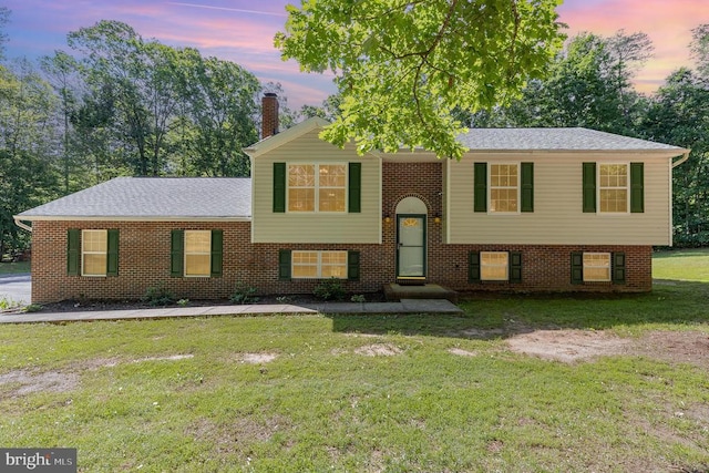 7001 Aspen Ln, Spotsylvania, VA 22551 - view of front facade featuring a yard, a chimney, entry steps, and brick siding
