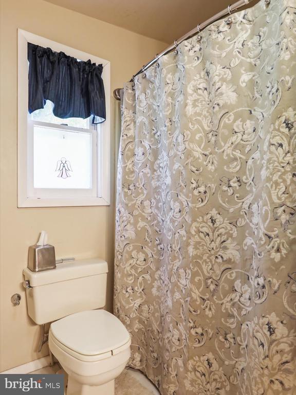  - full bathroom with tile patterned flooring and a shower with shower curtain