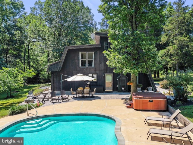  - outdoor pool with a hot tub and a patio