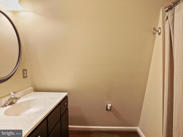  - bathroom featuring vanity and wood finished floors