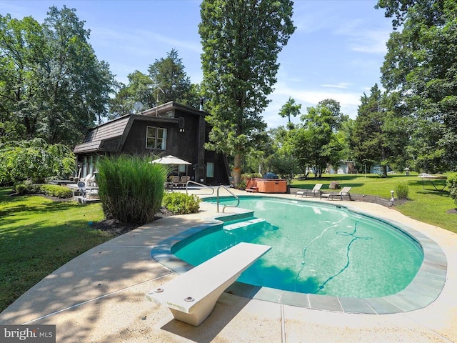  - outdoor pool featuring a hot tub, a patio area, a lawn, and a diving board