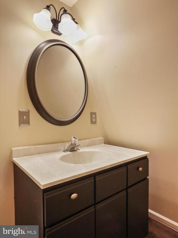  - bathroom featuring vanity and wood finished floors