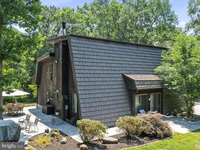  - view of side of home featuring a patio area and outdoor dining space