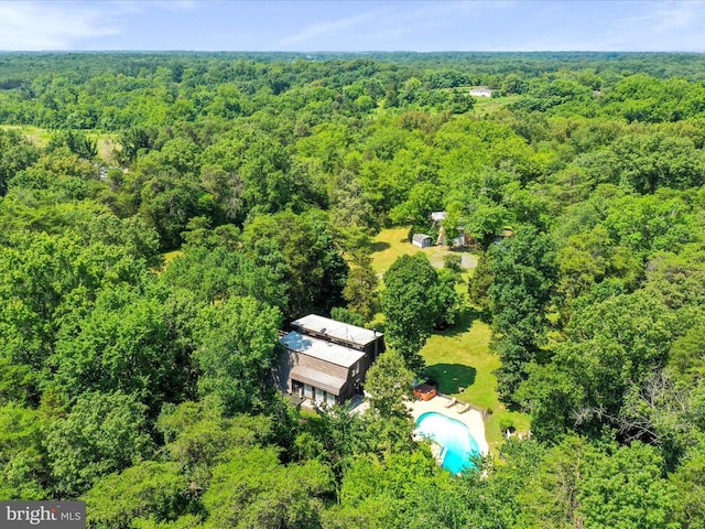 - aerial view of a heavily wooded area and a pool area