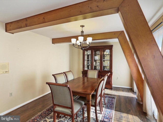  - dining area with a chandelier, beam ceiling, and wood finished floors