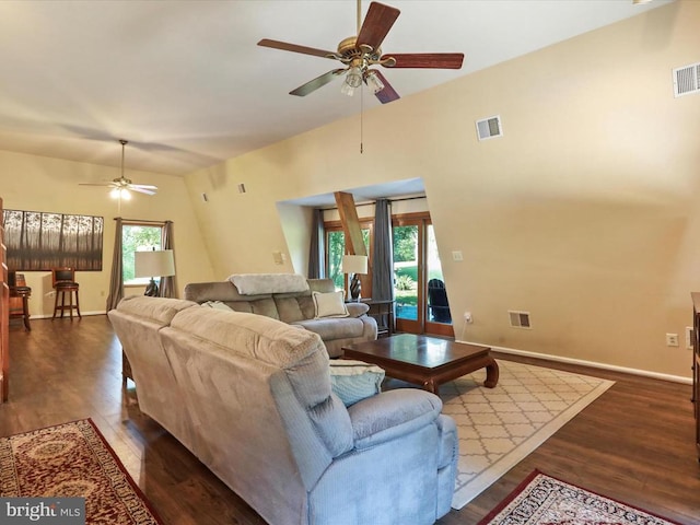  - living room with a ceiling fan and dark wood-type flooring