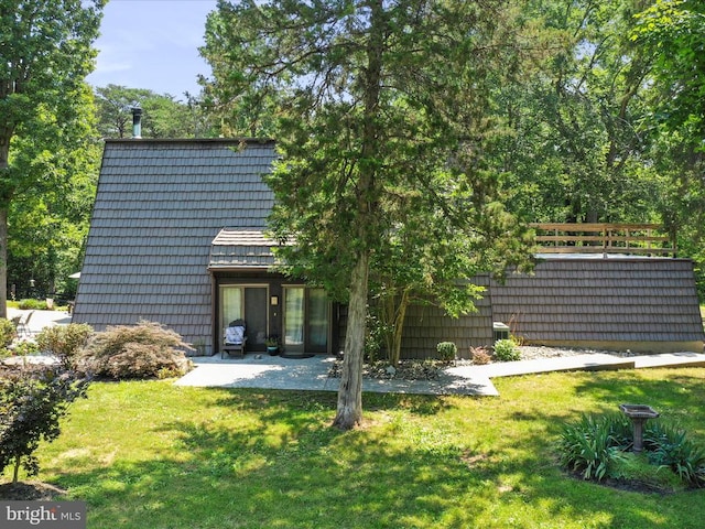  - rear view of house with a lawn and a patio area