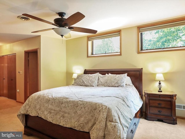  - bedroom featuring light colored carpet and ceiling fan