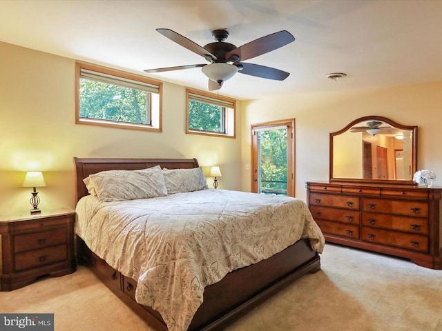  - bedroom with access to outside, light colored carpet, and a ceiling fan