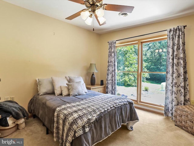  - carpeted bedroom with a ceiling fan