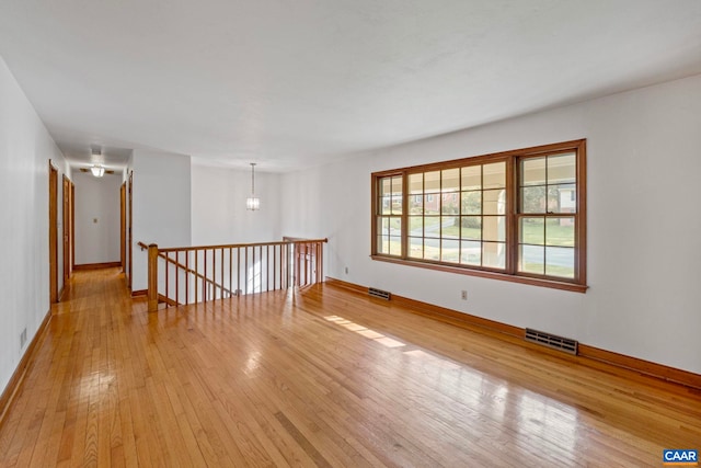 411 Westmoreland Ct, Charlottesville, VA 22901 - empty room with light wood-style flooring and a chandelier