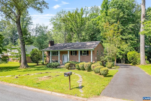 411 Westmoreland Ct, Charlottesville, VA 22901 - split foyer home featuring brick siding, a chimney, a front yard, and covered porch