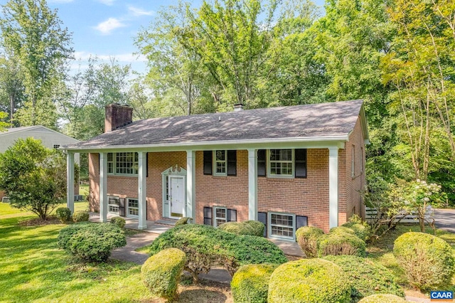 411 Westmoreland Ct, Charlottesville, VA 22901 - bi-level home featuring a chimney, brick siding, roof with shingles, and covered porch